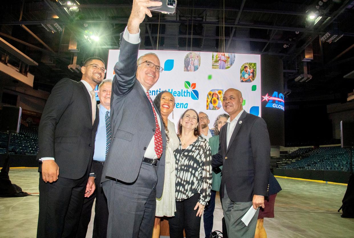 Stockton city councilman Michael Blower, center, takes a selfie with the mayor and other city officials after a ceremony rernaming the Stockton Arena to Adventist Health Arena in downtown Stockton on Oct. 24, 2023.