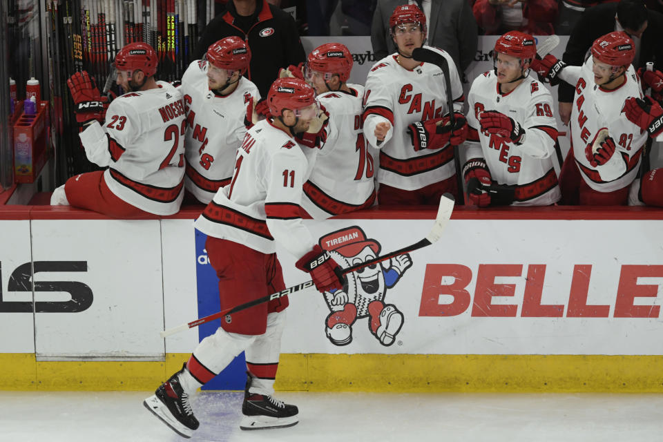 Carolina Hurricanes' Jordan Staal (11) celebrates with teammates on the bench after scoring during the second period of an NHL hockey game against the Chicago Blackhawks, Sunday, April 14, 2024, in Chicago. (AP Photo/Paul Beaty)