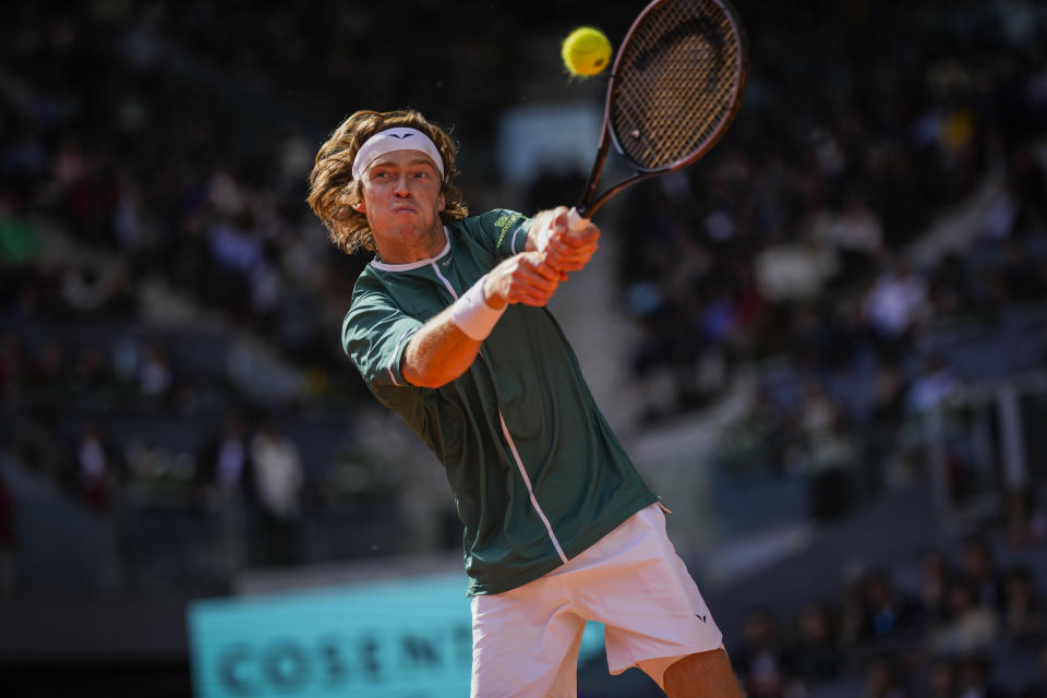 Andrey Rublev, of Russia, returns the ball to Taylor Fritz, of United States, during the Mutua Madrid Open tennis tournament in Madrid, Spain, Friday, May 3, 2024. (AP Photo/Bernat Armangue)