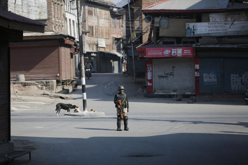 An Indian paramilitary soldier stands guard during a strike in Srinagar, Indian controlled Kashmir, Monday, Oct. 22, 2018. Armed soldiers and police have fanned out across much of Indian-controlled Kashmir as separatists challenging Indian rule called for a general strike to mourn the deaths of civilians and armed rebels during confrontation with government forces. (AP Photo/Mukhtar Khan)