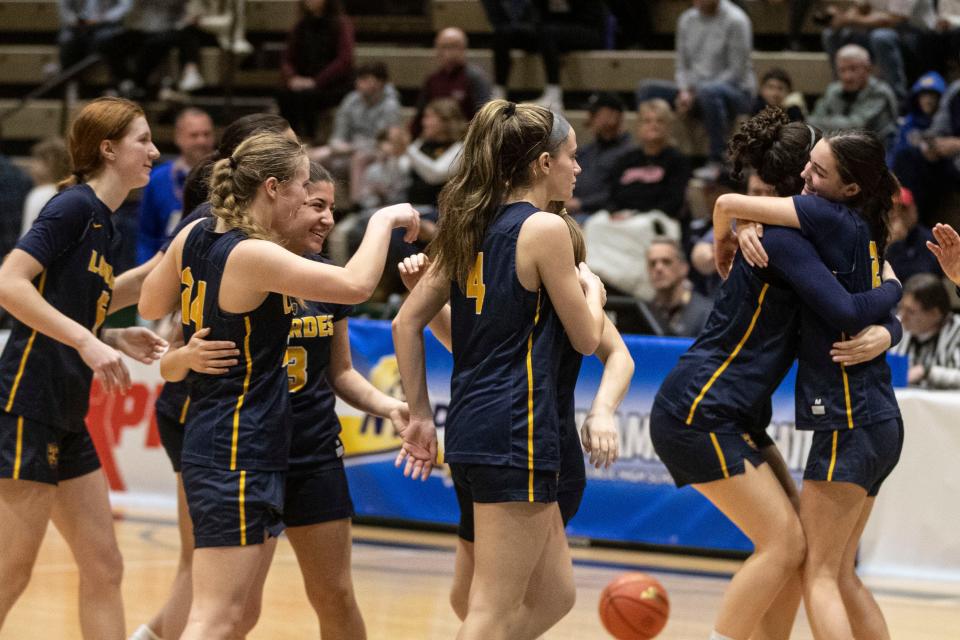 Our Lady of Lourdes celebrates after defeating Walt Whitman 60-51 in a New York State girls Class AAA basketball semifinal against at Hudson Valley Community College in Troy March 16, 2024.