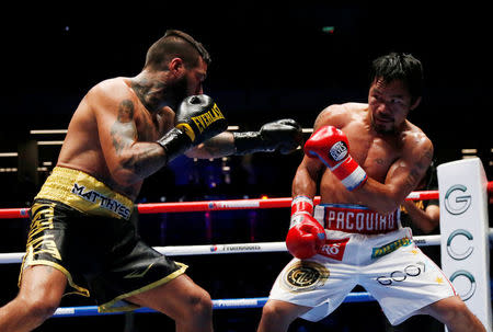 Boxing - WBA Welterweight Title Fight - Manny Pacquiao v Lucas Matthysse - Axiata Arena, Kuala Lumpur, Malaysia - July 15, 2018 Manny Pacquiao in action against Lucas Matthysse REUTERS/Lai Seng Sin