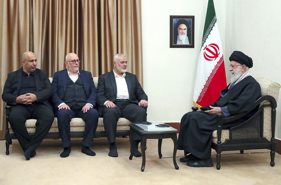 In this photo released by an official website of the office of the Iranian supreme leader, Supreme Leader Ayatollah Ali Khamenei, right, speaks in a meeting with Hamas chief Ismail Haniyeh, second right, and his delegation, in Tehran, Iran, Tuesday, March 26, 2024. A portrait of the late Iranian revolutionary founder Ayatollah Khomeini hangs on the wall. (Office of the Iranian Supreme Leader via AP)