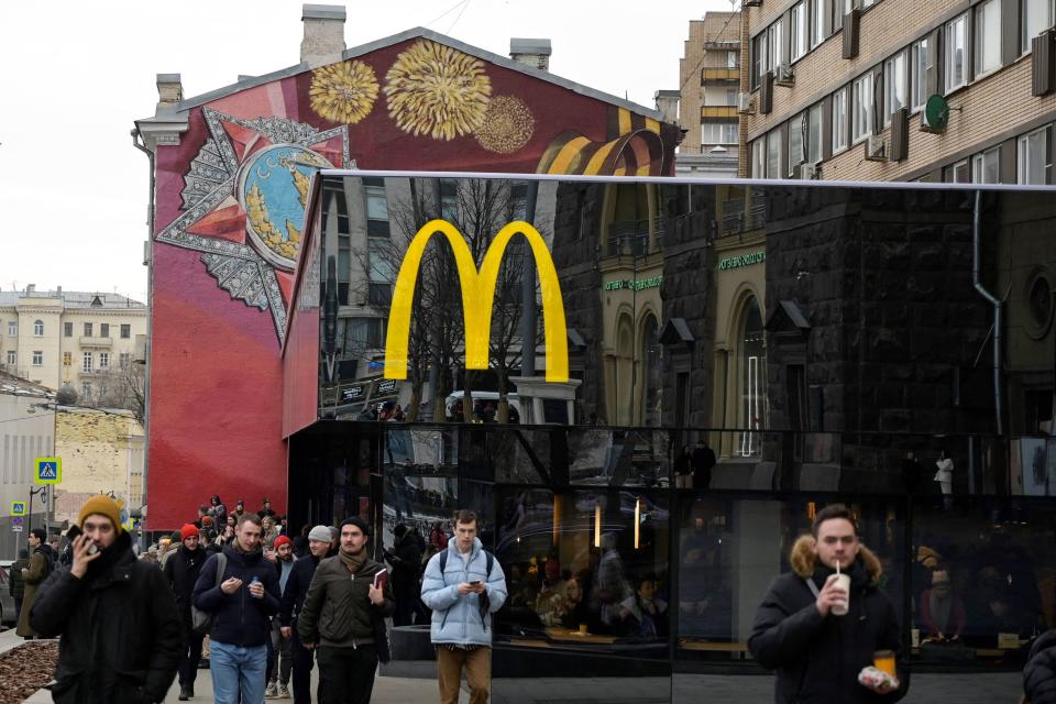 Men walk in front of the McDonald's flagship restaurant at Pushkinskaya Square - the first one of the chain opened in the USSR on January 31, 1990 - in central Moscow on March 13, 2022, McDonald's last day in Russia. - On February 24, Putin ordered Russian troops to pour into pro-Western Ukraine, triggering unprecedented Western sanctions against Moscow and sparking an exodus of foreign corporations including H&M, McDonald's and Ikea. (Photo by AFP) (Photo by -/AFP via Getty Images)