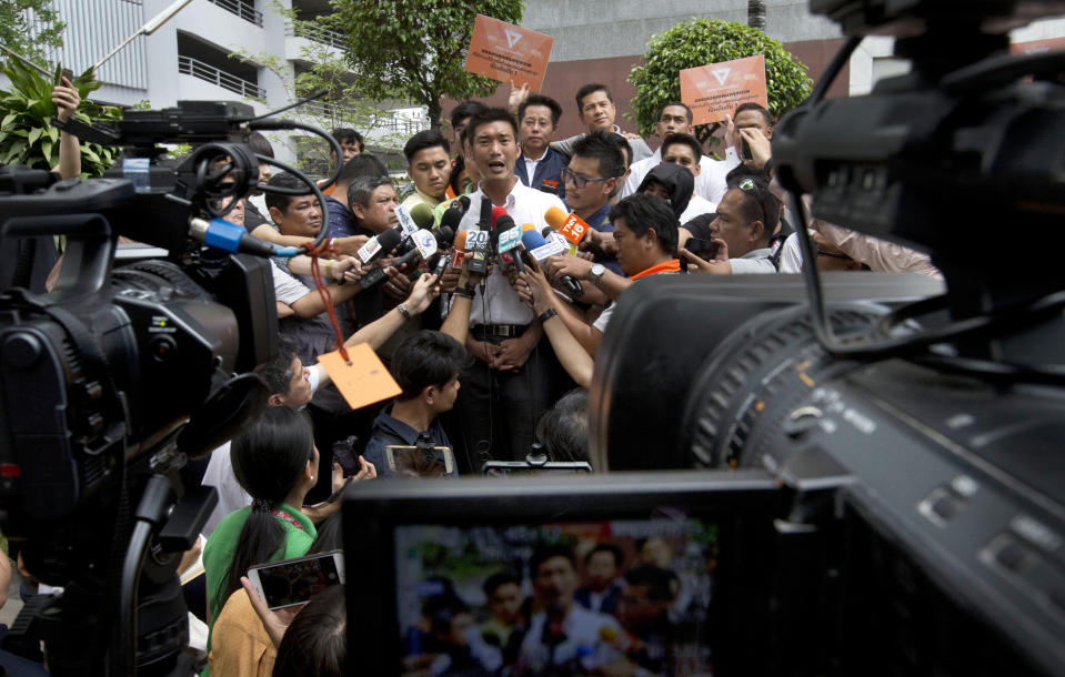 Thailand's Future Forward Party leader Thanathorn Juangroongruangkit, center, talks to media before taking a tour to thank people for their support in Bangkok, Thailand, Wednesday, April 3, 2019. Thailand's ruling junta has filed a complaint accusing Thanathorn of sedition and aiding criminals. The Future Forward Party ran a strong third in the elections last month that were also contested by a pro-military party. (AP Photo/Sakchai Lalit)