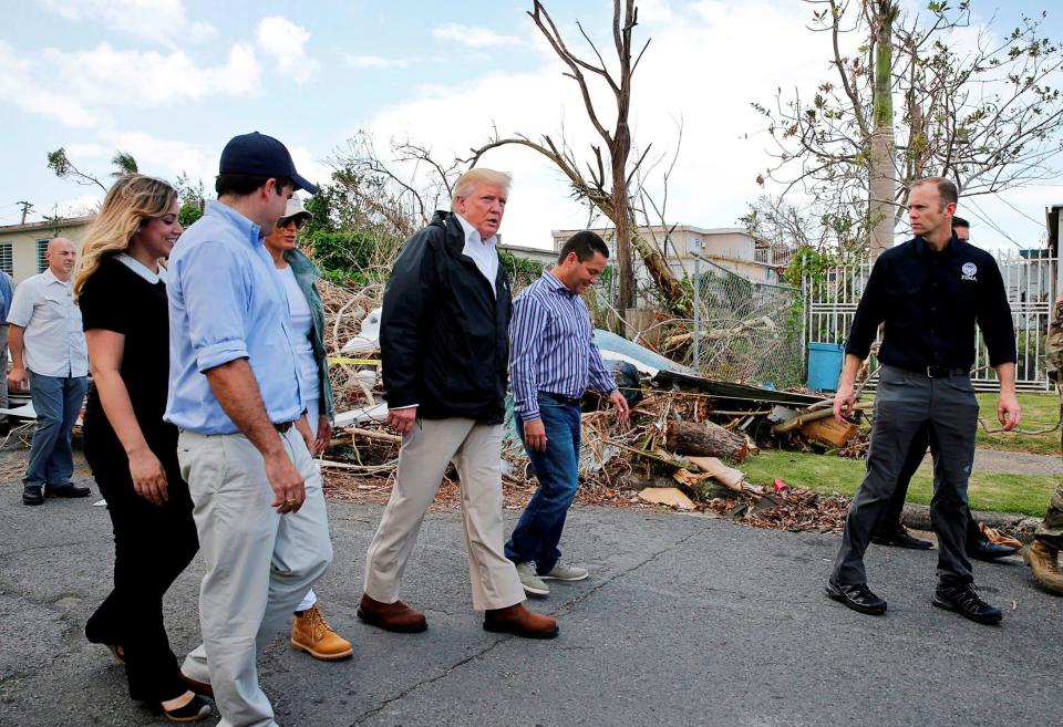 Image: President Trump walks past hurricane wreckage as he visits areas damaged by Hurricane Maria in Guaynabo, Puerto Rico (Jonathan Ernst / Reuters file)