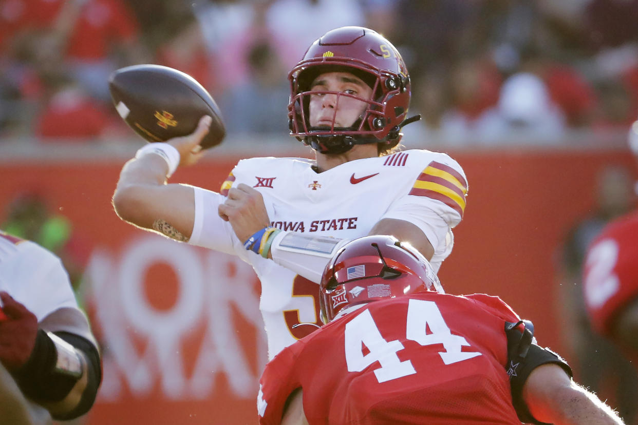 Iowa State quarterback Rocco Becht, back, looks to pass the ball under pressure from Houston linebacker Michael Batton (44) during the first half of an NCAA college football game, Saturday, Sept. 28, 2024, in Houston. (AP Photo/Michael Wyke)