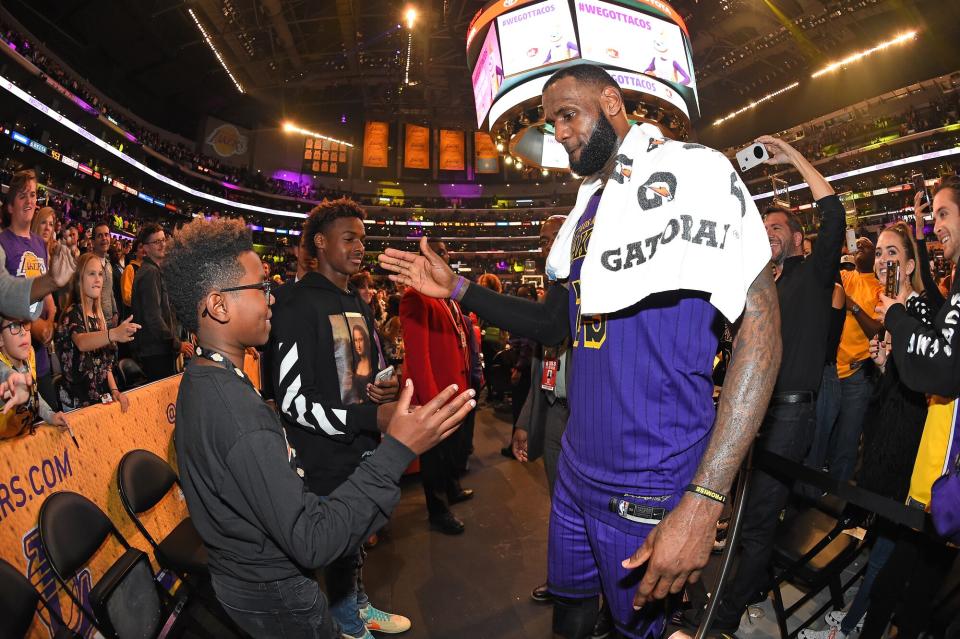 LeBron James #23 of the Los Angeles Lakers is seen shaking hands with his sons Bryce Maximus James and LeBron James Jr. after winning the game against the Utah Jazz on November 23, 2018 at STAPLES Center in Los Angeles, California.