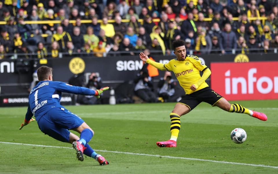 Jadon Sancho scores for Dortmund in a full stadium before lockdown  -  Lars Baron/Bongarts/Getty Images