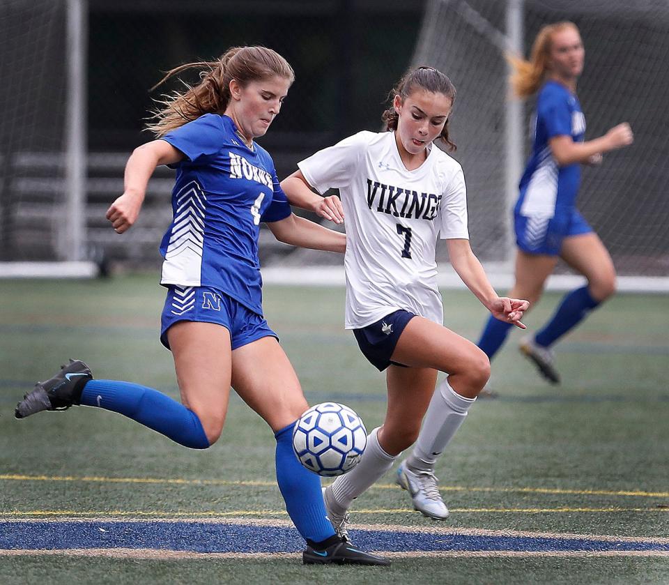 Norwell's Paige Flanders is challenged by East Bridgewater's Ella Sheehan. The Clippers and Vikings played to a 2-2 tie at Norwell on Monday, Sept. 12, 2022.