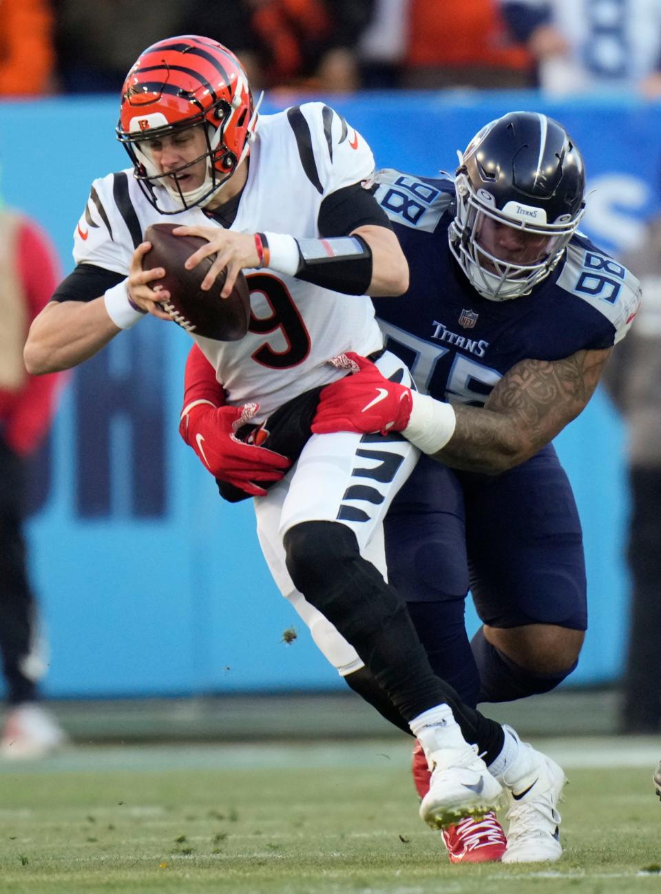 Tennessee Titans defensive tackle Jeffery Simmons (98) sacks Cincinnati Bengals quarterback Joe Burrow (9) during the first quarter of an AFC divisional playoff game at Nissan Stadium Saturday, Jan. 22, 2022 in Nashville, Tenn.