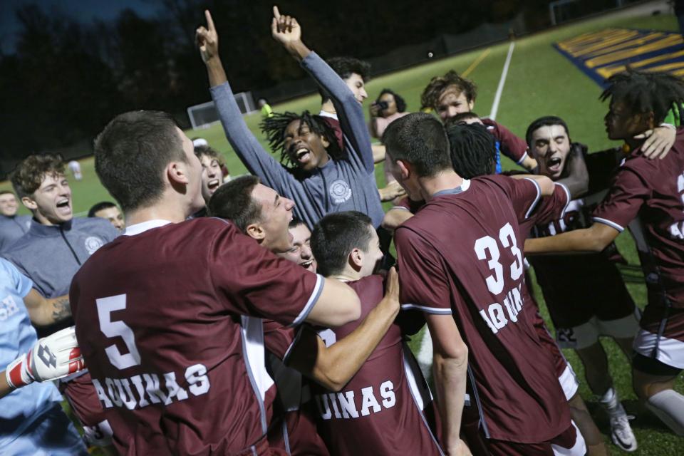 Aquinas players celebrate after the final buzzer giving them the victory over Pittsford Sutherland 2-0 in their Section V Class A championship final.