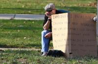 Edmond Aviv, 62, sits with a sign he made at a street corner in the Cleveland suburb of South Euclid, Ohio April 13, 2014. Aviv, who called his neighbor "Monkey Mama" as she held her adopted, disabled African-American children, and has smeared dog feces on their wheelchair ramp, was ordered by a judge to carry an "I AM A BULLY!" sign on the busy street on Sunday. REUTERS/Aaron Josefczyk (UNITED STATES - Tags: CRIME LAW SOCIETY TRANSPORT TPX IMAGES OF THE DAY)