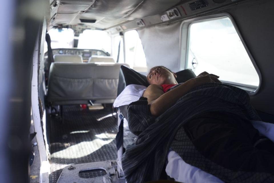 In this Sept. 8, 2018, photo, 42-year-old dialysis patient Sandra Medina waits inside a plane at the airport in Vieques, Puerto Rico. After Hurricane Maria hit, authorities began flying kidney patients in Vieques to the Puerto Rican mainland. The storm had ruined the only dialysis center on this tiny island; without treatment, the patients would die.