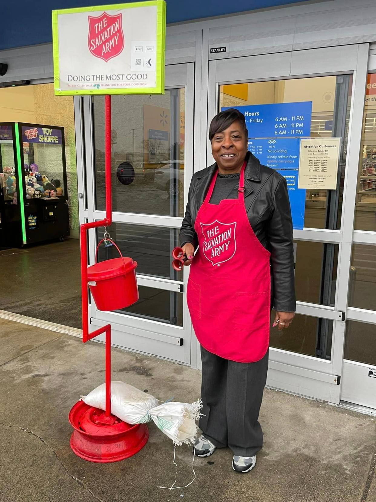 Salvation Army volunteer bell ringer ringing in Christmas cheer