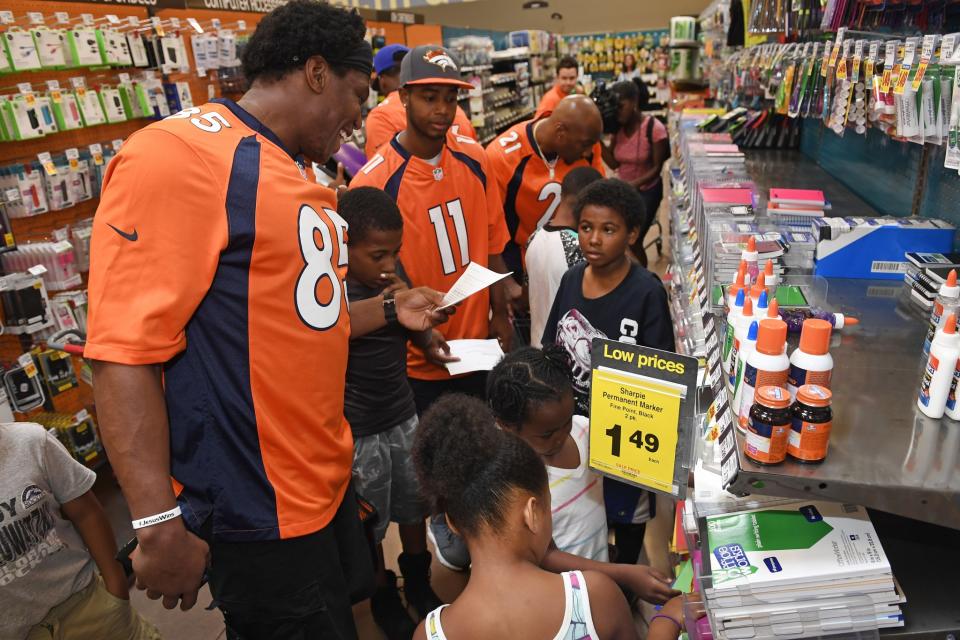 <p>Denver Broncos tight end Virgil Green, #85 and wide receiver Jordan Norwood, #11, shop with Samari Jelks, 12, in the middle and Darrell Hugley-Jones, 9 on right, for school supplies at King Soopers Marketplace on July 25, 2016 in Parker, Colorado. </p>