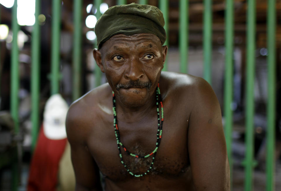 In this Sept. 8, 2012 photo, Ernesto Fernandez, 59, works during repairs on the sugar processing plant "Brasil" in Jaronu, Cuba. The Brasil sugar plant, launched in 1921, is getting a makeover and is expected to be ready in time for the upcoming annual harvest and start milling cane by February. (AP Photo/Franklin Reyes)