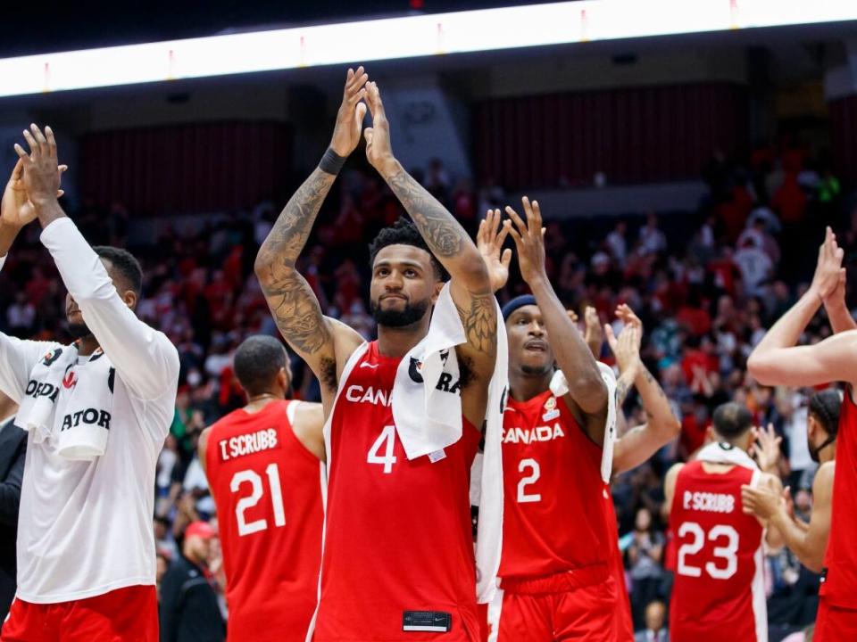 Nickeil Alexander-Walker, centre, and Canadian national teammates applaud the crowd after a July game in Hamilton, Ont. Canada Basketball on Thursday announced its training camp roster for an upcoming World Cup qualifying window. (Cole Burston/The Canadian Press - image credit)