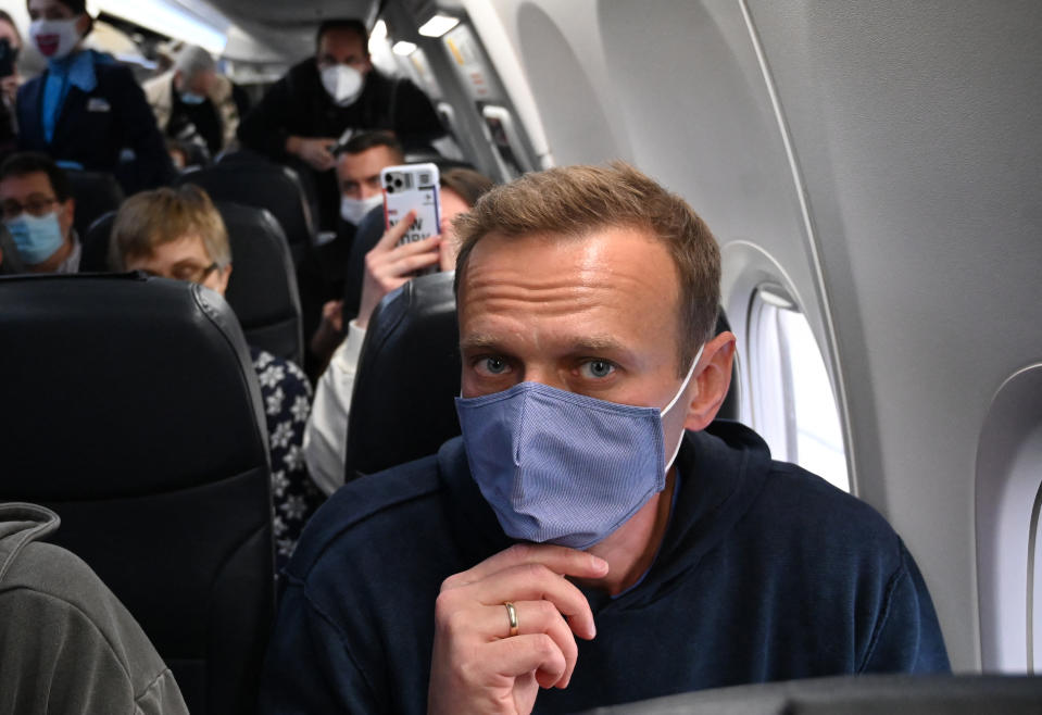 TOPSHOT - Russian opposition leader Alexei Navalny sits in a Pobeda airlines plane heading to Moscow before take-off from Berlin Brandenburg Airport (BER) in Schoenefeld, southeast of Berlin, on January 17, 2021. Chief Kremlin critic Alexei Navalny returns to Russia from Germany on January 17, facing imminent arrest after authorities warned they would detain him. The 44-year-old opposition leader is flying back to Moscow after spending several months in Germany recovering from a poisoning attack that he said was carried out on the orders of President Vladimir Putin. (Photo by Kirill KUDRYAVTSEV / AFP) (Photo by KIRILL KUDRYAVTSEV/AFP via Getty Images)