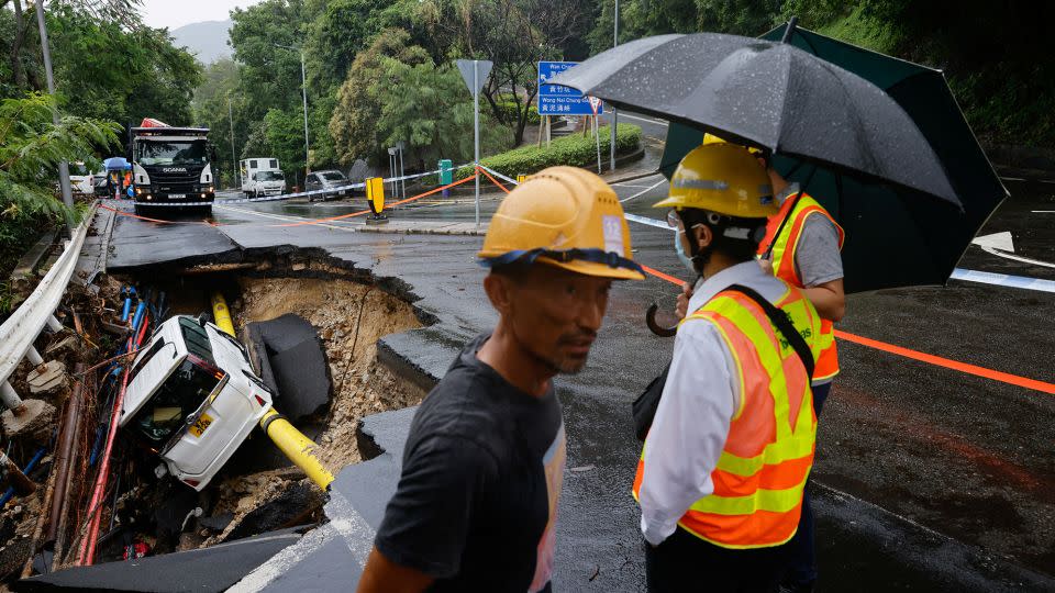 A vehicle in a collapsed road section after flood and heavy rains, in Hong Kong, China, September 8, 2023.  - Tyrone Siu/Reuters