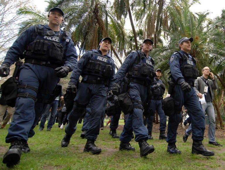 Illustration of armed police in Sydney, Australia. Some 350 police took part in dawn raids at 30 properties across Sydney and elsewhere in New South Wales state targeting the Hells Angels, Rebels and Comancheros, as well as Asian and Balkan crime organisations, police said