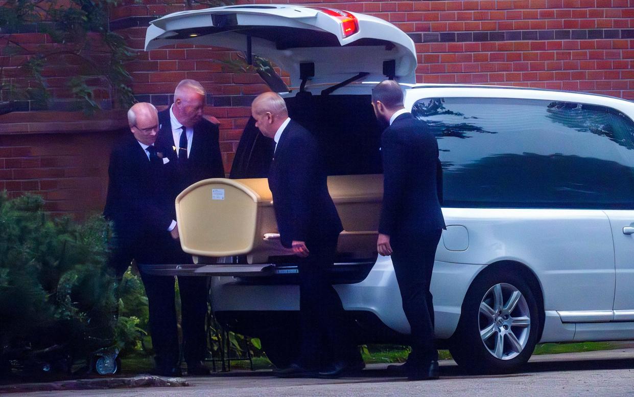 Pallbearers lift Eriksson's coffin from the hearse - Sven-Goran Eriksson funeral: Candle in the Wind plays as David Beckham joins mourners