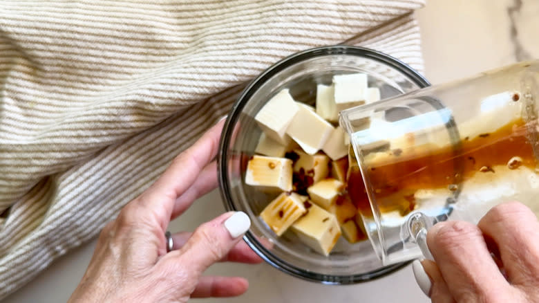 pouring marinade over tofu