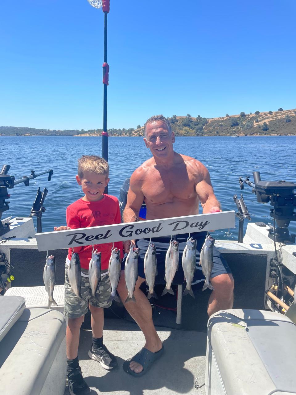 Chris Podesto and his grandson Luca Podesto show off their catches of the day after fishing.