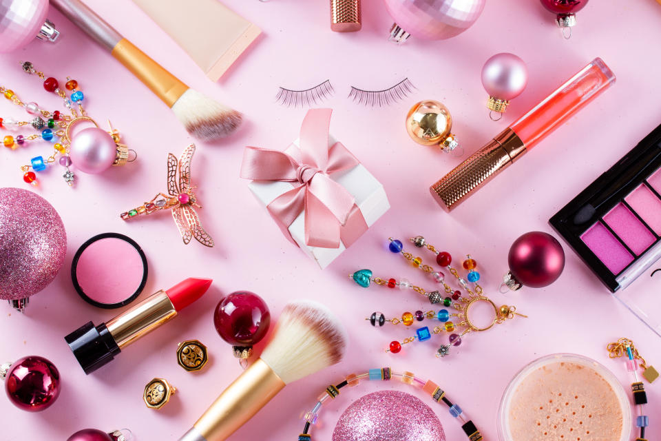 Festive make up products on pink background