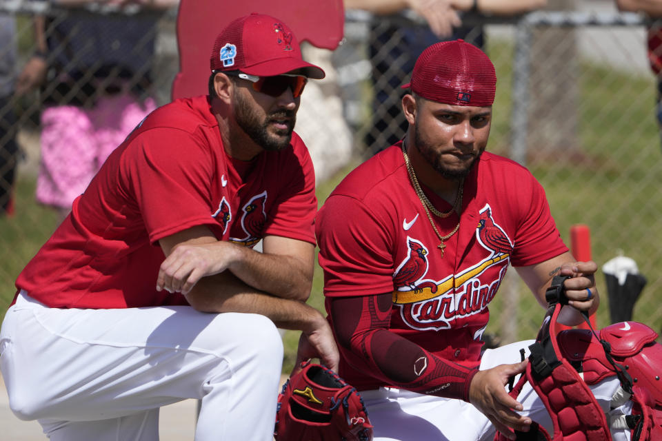 St. Louis Cardinals pitcher Adam Wainwright, left, talks with catcher Willson Contreras during spring training baseball practice Wednesday, Feb. 15, 2023, in Jupiter, Fla. (AP Photo/Jeff Roberson)