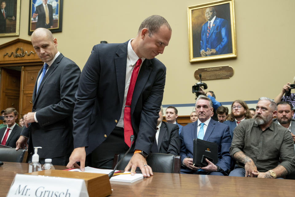 Ryan Graves, Americans for Safe Aerospace Executive Director, left, and U.S. Air Force (Ret.) Maj. David Grusch, arrive to testify before a House Oversight and Accountability subcommittee hearing on UFOs, Wednesday, July 26, 2023, on Capitol Hill in Washington. (AP Photo/Nathan Howard)