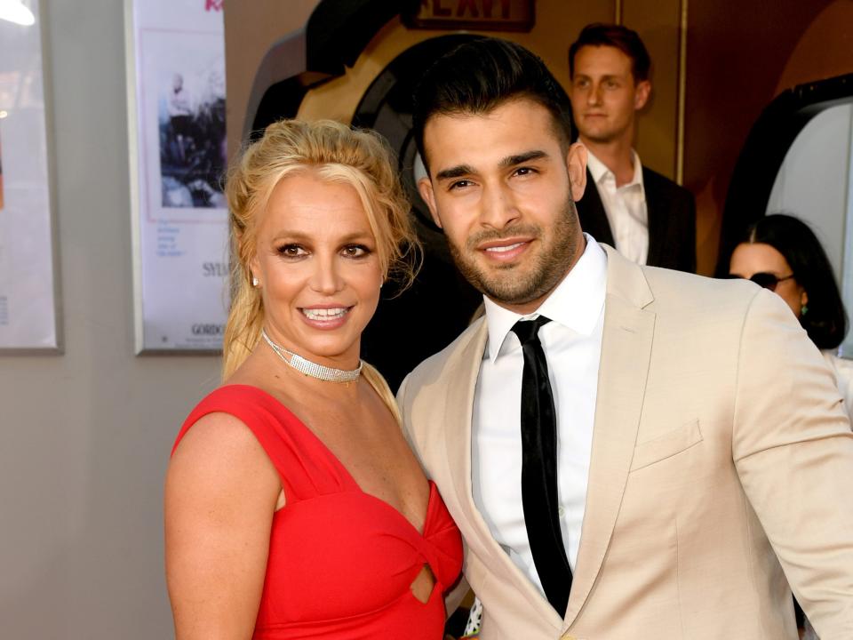 Britney Spears and Sam Asghari on a red carpet in 2019.