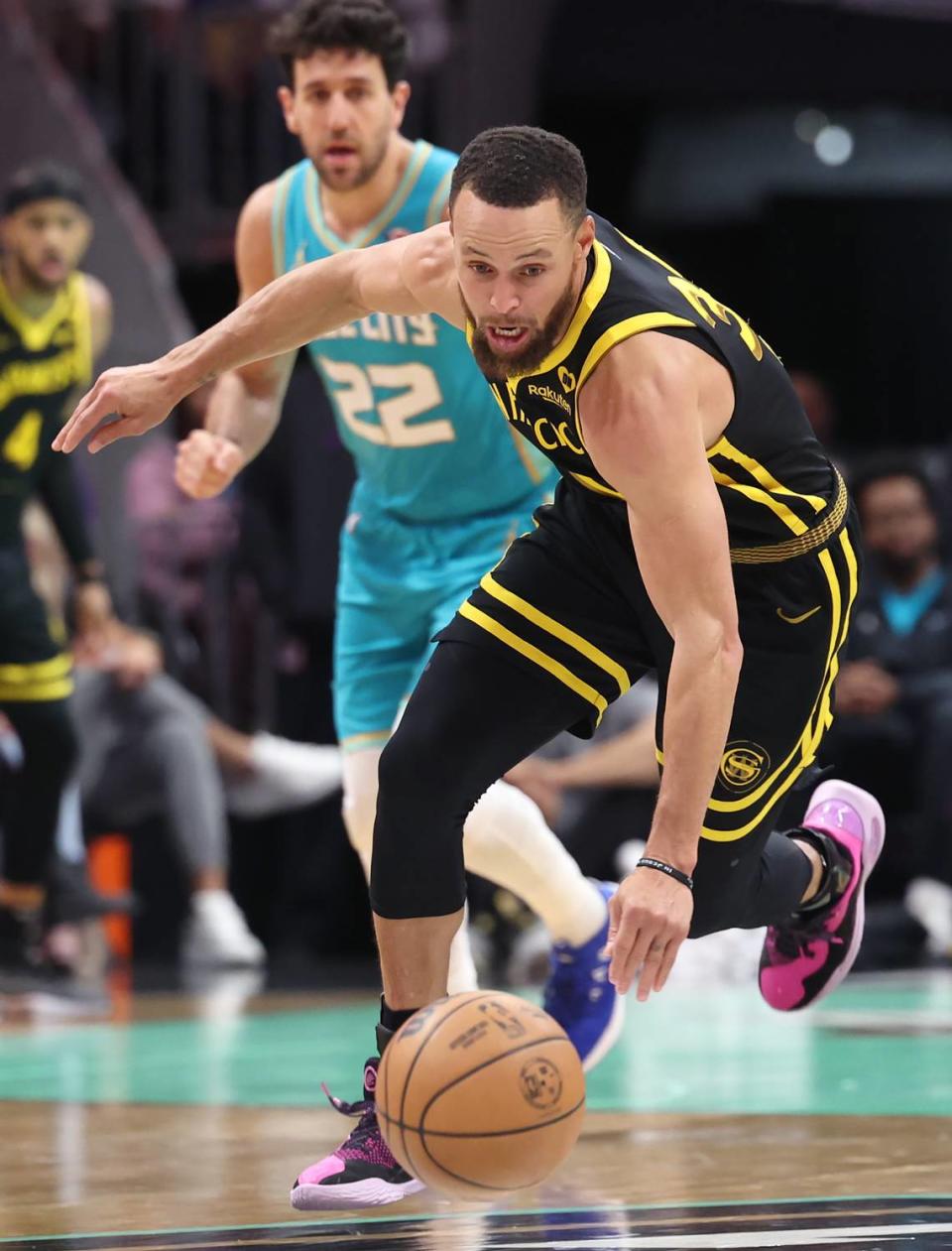Golden State Warriors guard Steph Curry chases after a loose ball during second-half action against the Charlotte Hornets at Spectrum Center in Charlotte, NC on Friday, March 29, 2024. The Warriors defeated the Hornets 115-97.