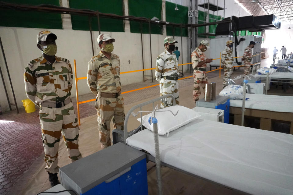 Indo-Tibetan Border Police (ITBP) personnel stand guard inside the campus hall of spiritual organisation Radha Soami Satsang Beas, converted into Sardar Patel COVID Care Centre, amidst the rising coronavirus cases in New Delhi, India. The national capital logged 24,331 fresh COVID-19 cases and a record single-day jump of 348 deaths on Friday, according to the latest health bulletin. (Photo by Mayank Makhija/NurPhoto via Getty Images)