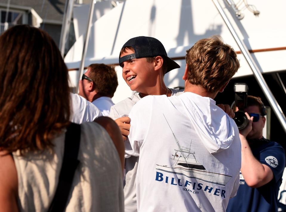 The crew of the Billfisher celebrate Jeremy Duffie and his 77.5 pound white marlin at the White Marlin Open Friday, Aug. 12, 2022, in Ocean City, Maryland.