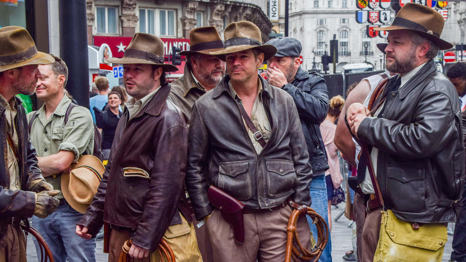 Fans dressed as Indiana Jones attend the premiere of 