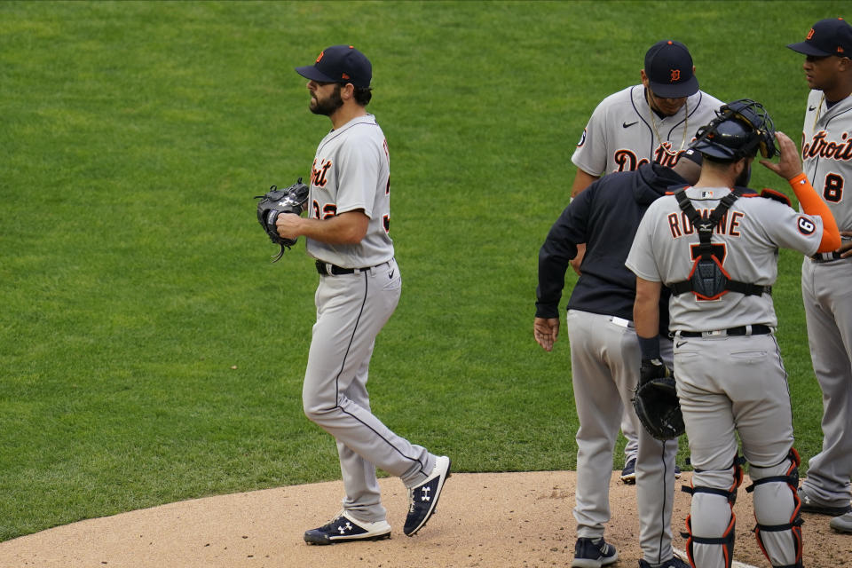 Detroit Tigers pitcher Michael Fulmer, left, leaves in the third inning after he was pulled in a baseball game against the Minnesota Twins, Monday, Sept. 7, 2020, in Minneapolis. (AP Photo/Jim Mone)