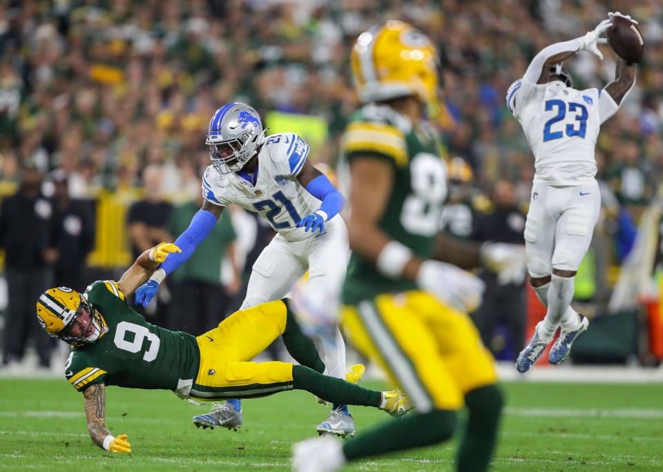 Green Bay Packers wide receiver Christian Watson (9) is knocked to the ground by Detroit Lions safety <a class="link " href="https://sports.yahoo.com/nfl/players/31052" data-i13n="sec:content-canvas;subsec:anchor_text;elm:context_link" data-ylk="slk:Tracy Walker;sec:content-canvas;subsec:anchor_text;elm:context_link;itc:0">Tracy Walker</a> III as cornerback <a class="link " href="https://sports.yahoo.com/nfl/players/33768" data-i13n="sec:content-canvas;subsec:anchor_text;elm:context_link" data-ylk="slk:Jerry Jacobs;sec:content-canvas;subsec:anchor_text;elm:context_link;itc:0">Jerry Jacobs</a> (23) intercepts a pass during their football game on Thursday, September 28, 2023, at Lambeau Field in Green Bay, Wis. Tork Mason/USA TODAY NETWORK-Wisconsin