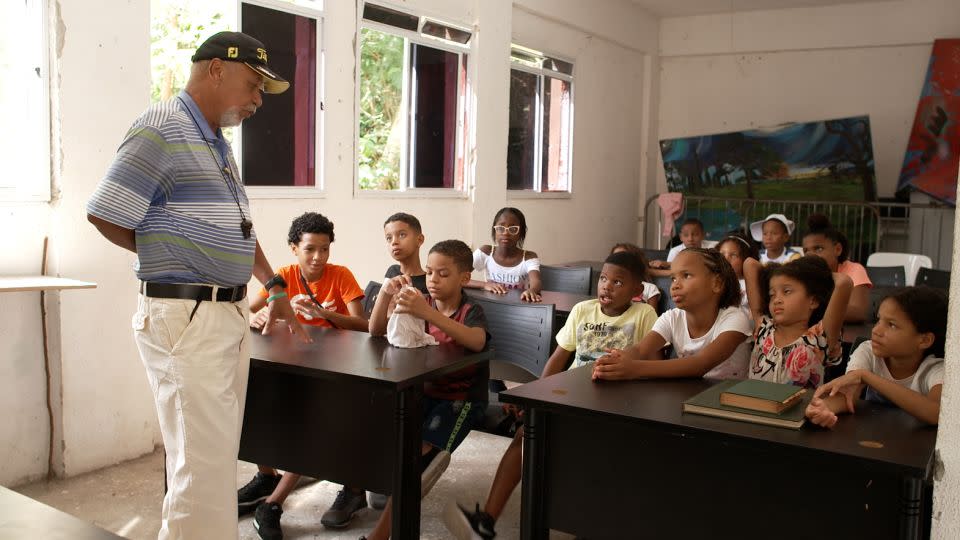 Tiago Albuquerque teaches English to children from Modesto’s golf academy. - Cameron Bauer/CNN