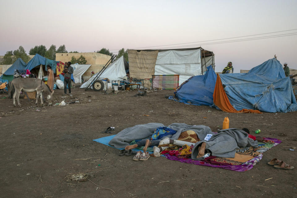 Tigray refugees who fled the conflict in the Ethiopia's Tigray sleep at Hamdeyat Transition Center near the Sudan-Ethiopia border, eastern Sudan, Thursday, Dec. 3, 2020. Ethiopian forces on Thursday blocked people from the country's embattled Tigray region from crossing into Sudan at the busiest crossing point for refugees, Sudanese forces said.(AP Photo/Nariman El-Mofty)