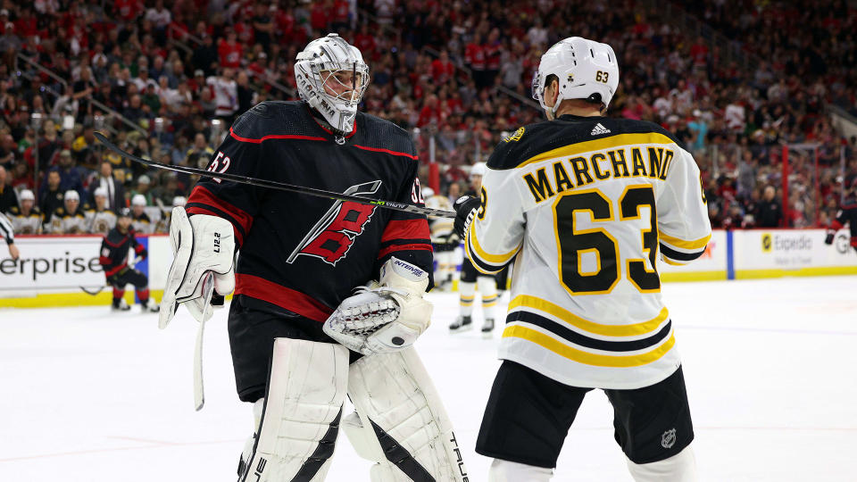 Goaltender Pyotr Kochetkov of the Carolina Hurricanes squares up after a hit in the crease from Brad Marchand. (Photo by Gregg Forwerck/NHLI via Getty Images)