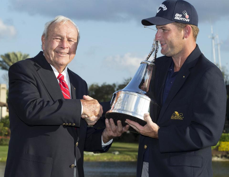 Arnold Palmer presents the trophy to Matt Every, right, after Every won the Arnold Palmer Invitational golf tournament at Bay Hill, Sunday, March 23, 2014, in Orlando, Fla. (AP Photo/Willie J. Allen Jr.)