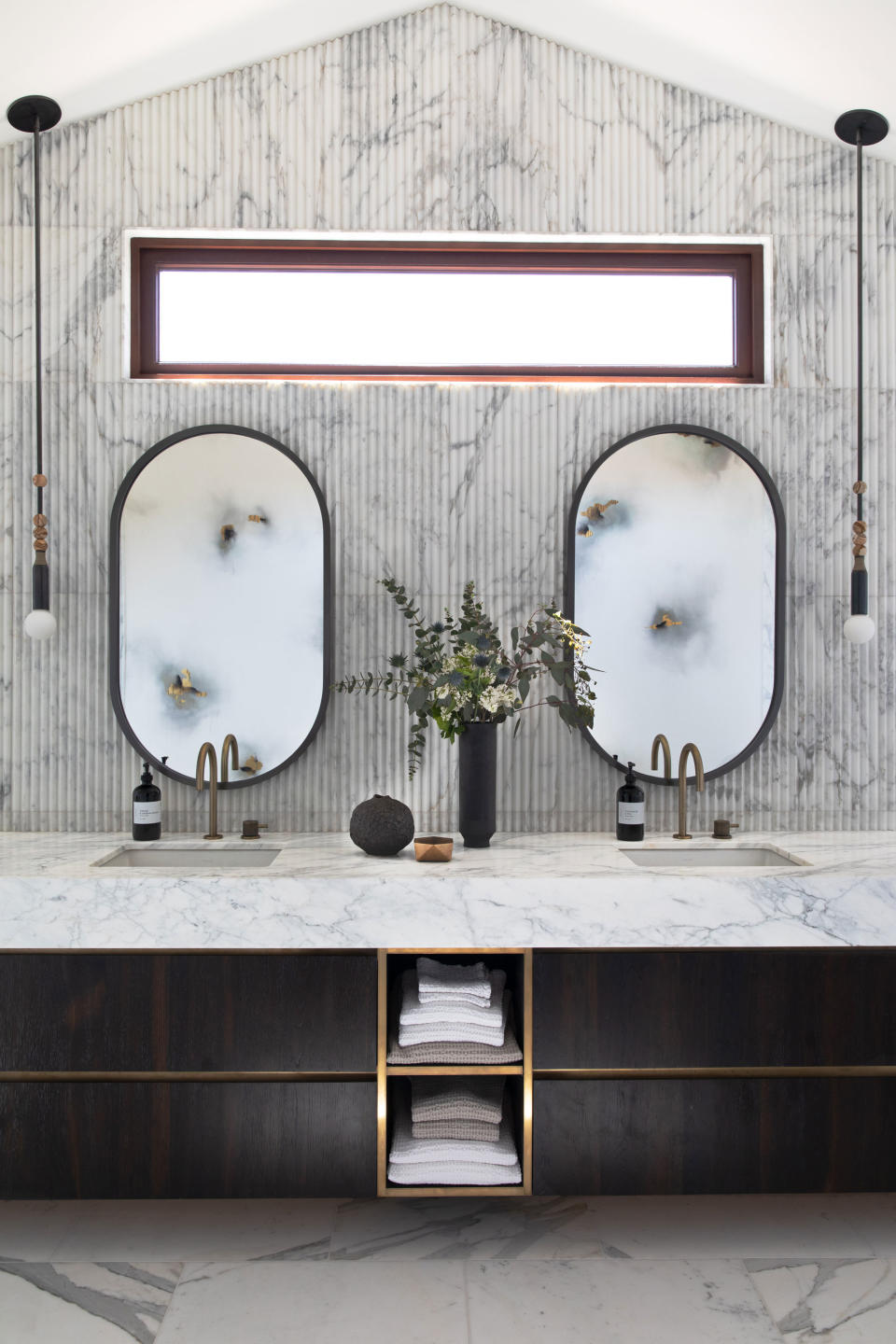 a bathroom with integrated towel storage