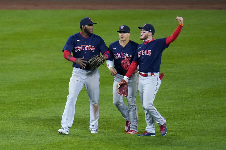 Boston Red Sox outfielders, from left, Franchy Cordero, Enrique Hernandez and Alex Verdugo react after defeating the Baltimore Orioles 6-4 in ten innings during a baseball game, Saturday, April 10, 2021, in Baltimore. (AP Photo/Julio Cortez)