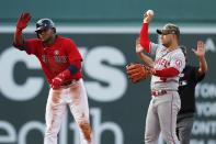 Boston Red Sox's Franchy Cordero, left, reacts after his RBI-double beside Los Angeles Angels' Jose Iglesias (4) during the sixth inning of a baseball game, Saturday, May 15, 2021, in Boston. (AP Photo/Michael Dwyer)