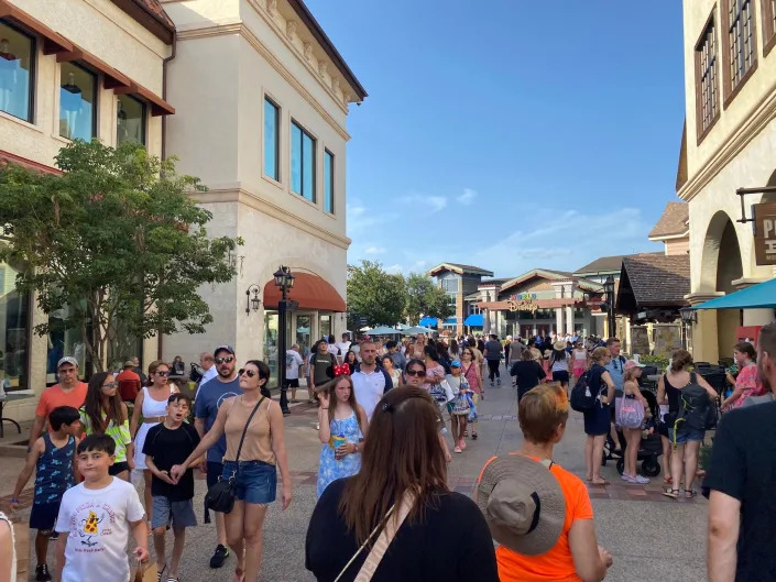 A crowded view of Disney Springs in July 2022.