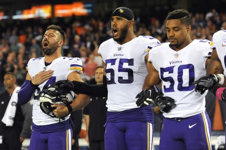 FILE PHOTO: Minnesota Vikings safety Andrew Sendejo (left) and linebacker Anthony Barr (center) sing the national anthem prior to a game against the Chicago Bears at Soldier Field, October 9, 2017; Chicago, IL, USA. Mandatory Credit: Patrick Gorski-USA TODAY Sports