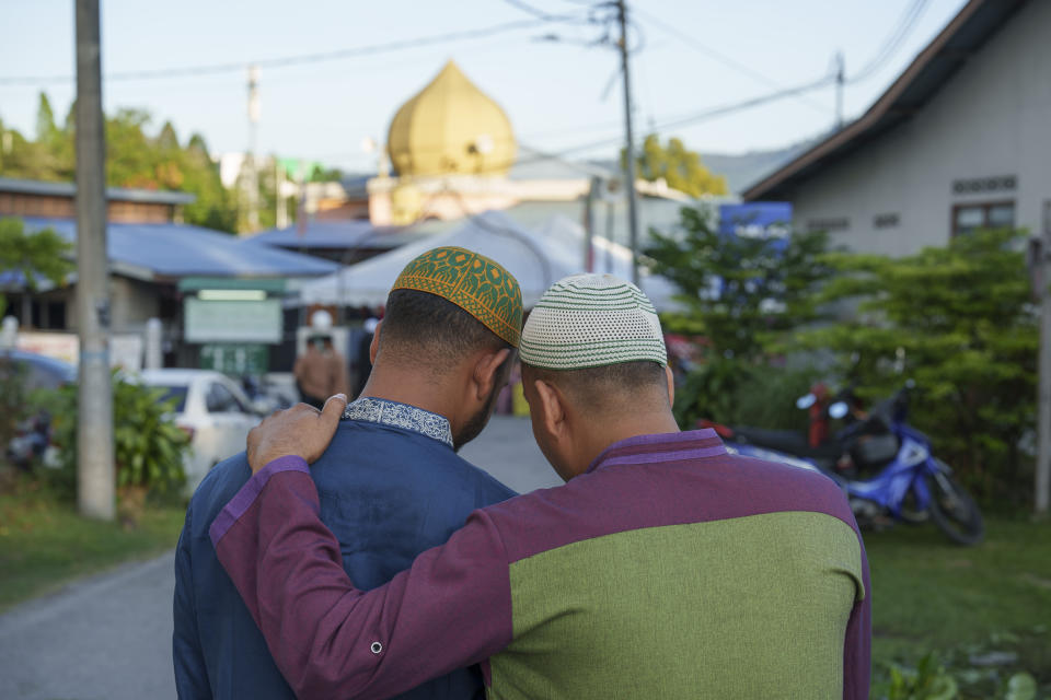 Muslims walk to a mosque for morning prayer during the Islamic holiday of Eid al-Adha, or the Feast of the Sacrifice, in Selayang on the outskirts of Kuala Lumpur, Malaysia, Thursday, June 29, 2023. (AP Photo/Vincent Thian)