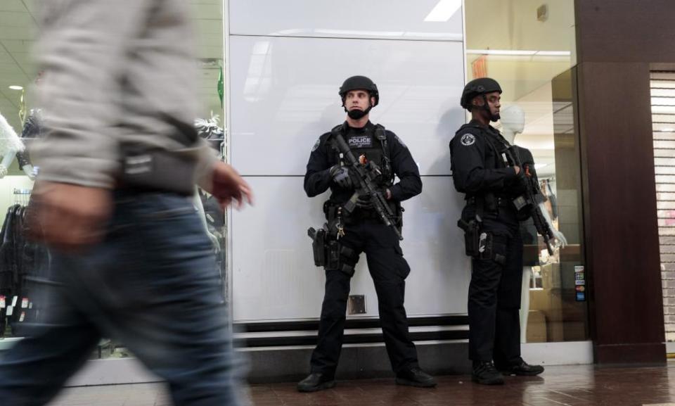 NYPD police stand guard inside the New York Port Authority Bus Terminal in the city after it reopened following an explosion on December 11, 2017