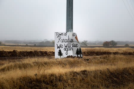FILE PHOTO: A handwritten sign is seen on a telephone poll on the road to Paradise in Chico, California, U.S. November 21, 2018. REUTERS/Elijah Nouvelage